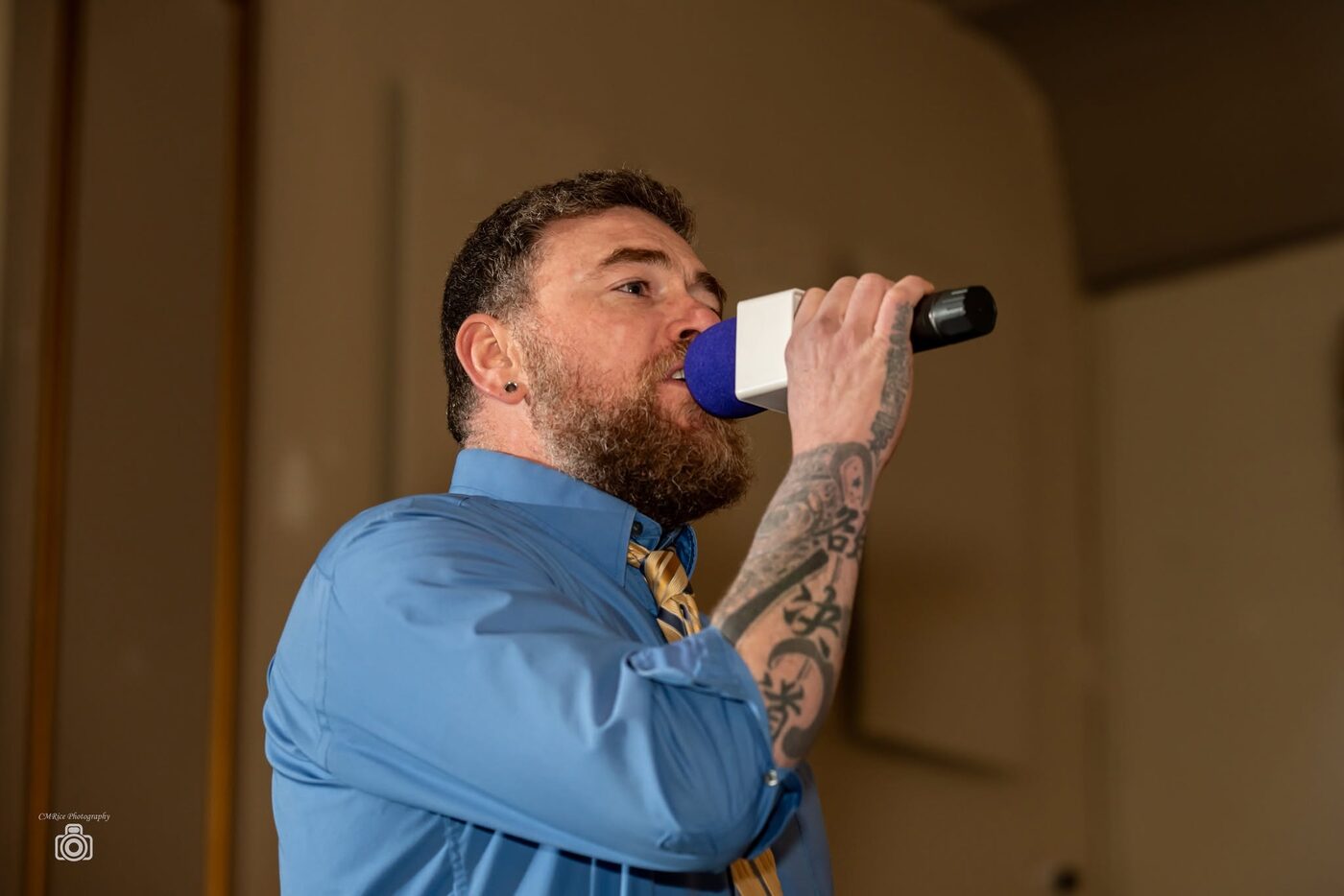 An on-screen personality speaks into a microphone